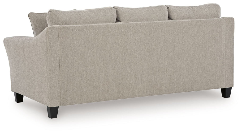 Taupe upholstered sofa with tufted seat cushions, back pillows, dark legs