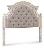 Chipped white upholstered headboard with arched silhouette and tufted button back