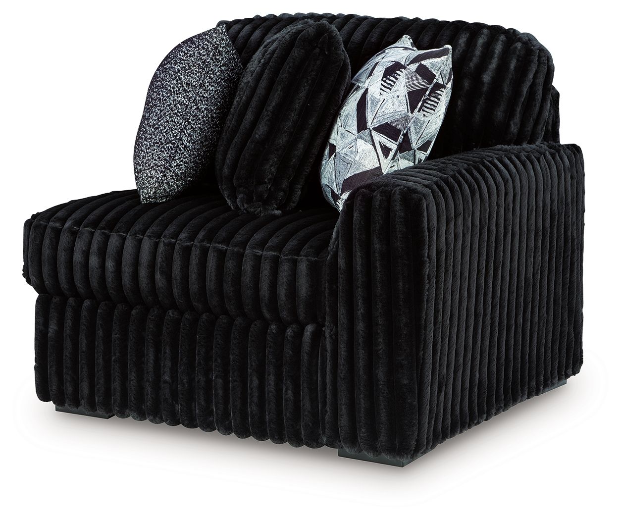 Onyx corduroy corner chair with ribbed upholstery and geometric throw pillow