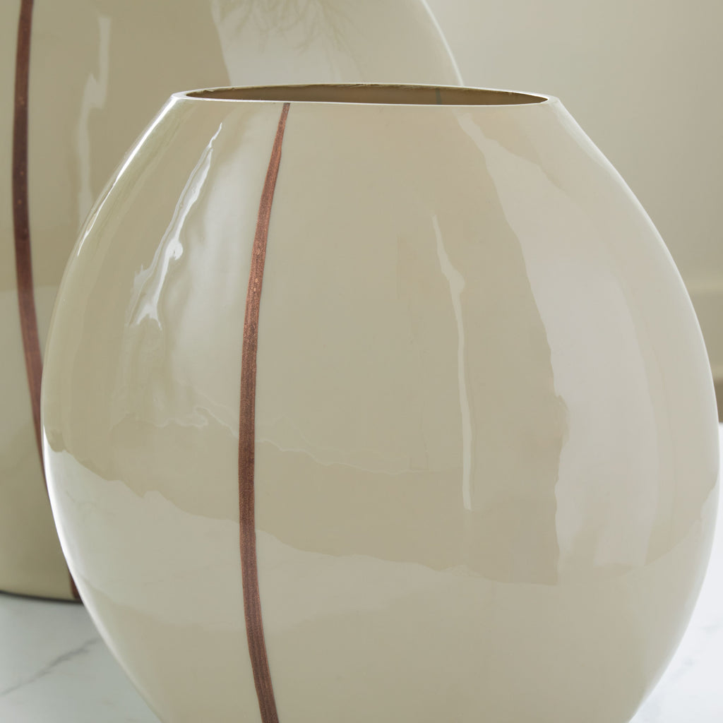 Beige ceramic vase close view with glossy finish and vertical brown stripe