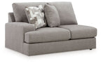 Smoke gray upholstered loveseat with left-facing armrest and two accent pillows.