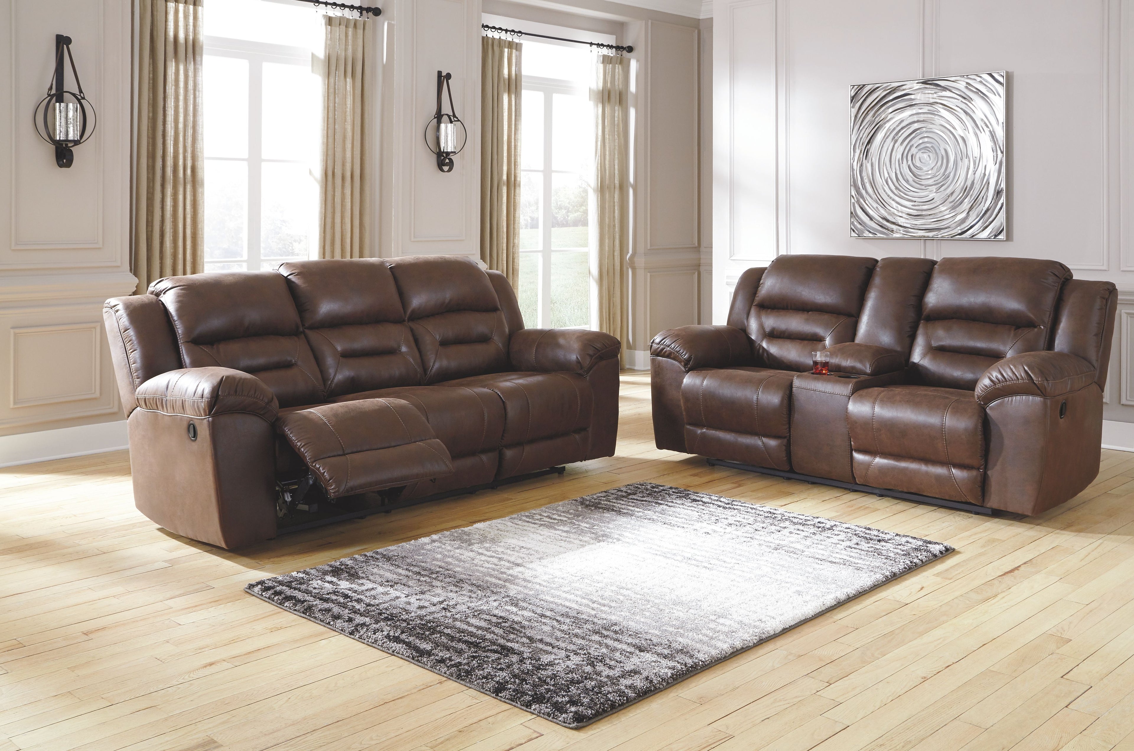 Dark brown reclining sofa and loveseat with padded armrests and tufted cushions
