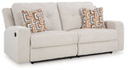 Light stone 2-seat reclining sofa with geometric pattern pillows and corner arm details