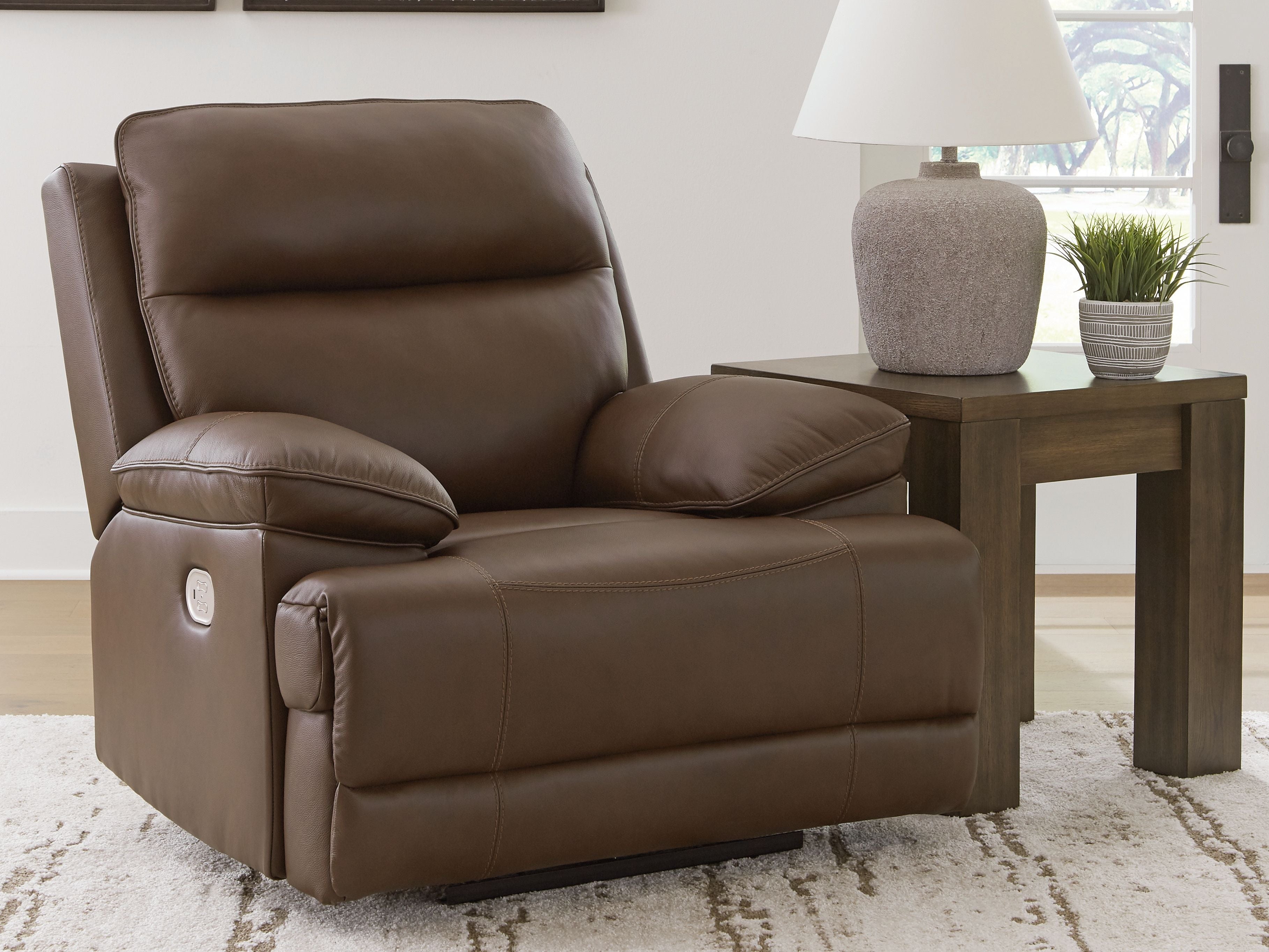 Tobacco brown power recliner chair with adjustable headrest and wide cushioned arms