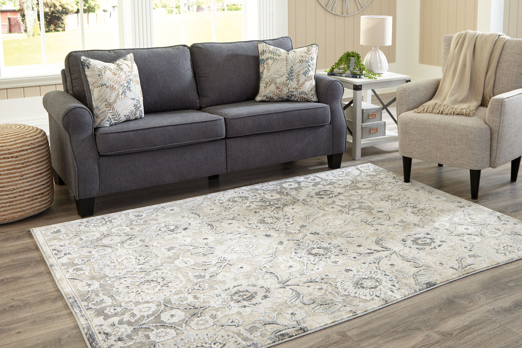 Ornate gray and cream area rug with scrolling floral scrollwork pattern