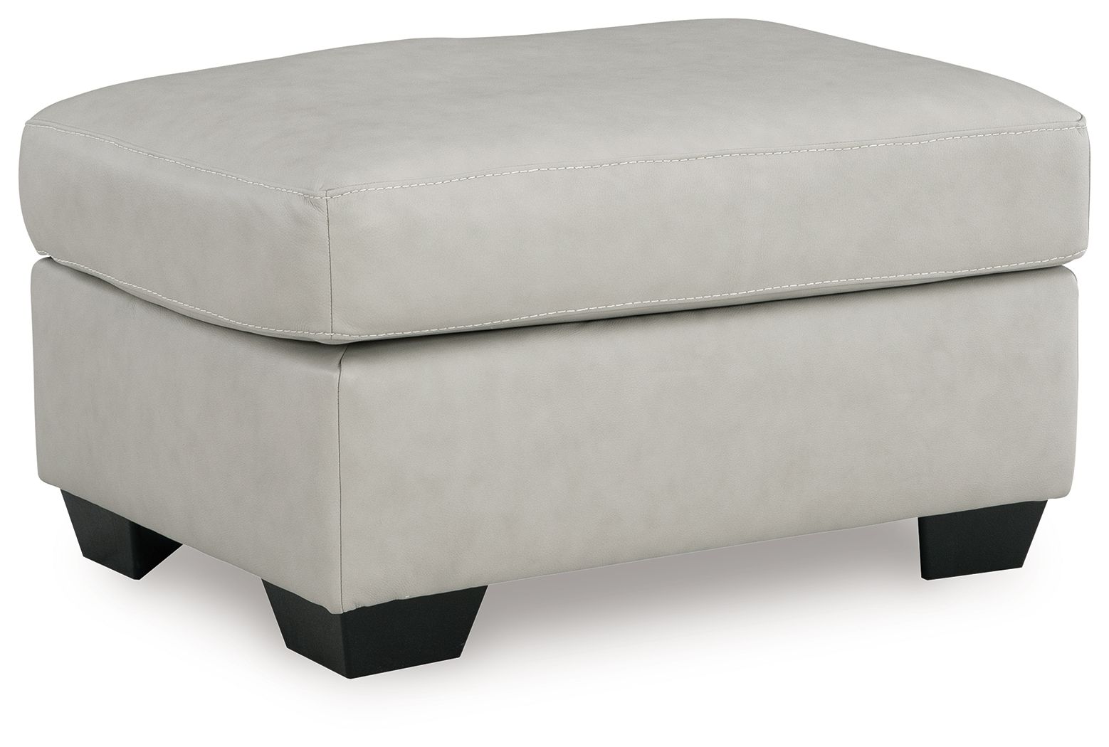 Light beige upholstered ottoman with cushioned top and double-stitched edge