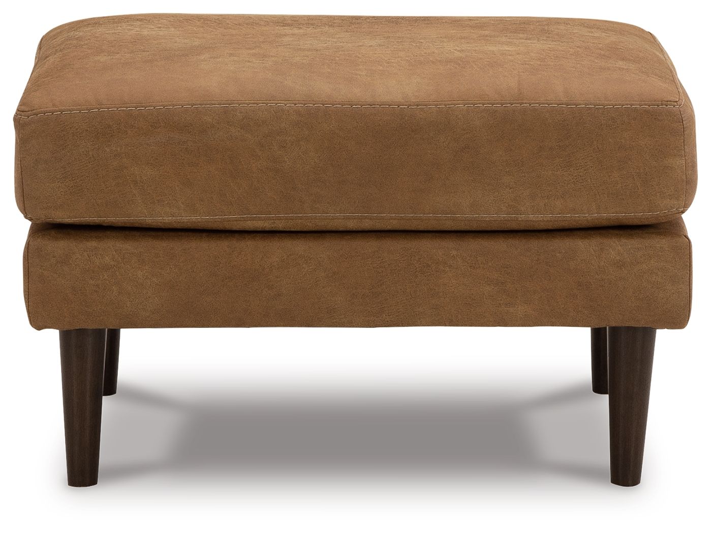 Caramel ottoman with low profile, horizontal seam, and dark wooden legs