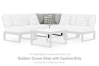 White outdoor corner chair with seat cushion and patterned throw pillows