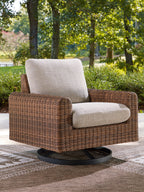 Woven swivel lounge chair with gray cushion, dark brown wicker frame, black circular base