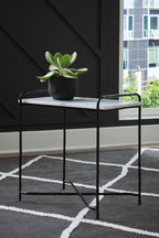 Accent table with white marble-look top, black frame and potted plant on top