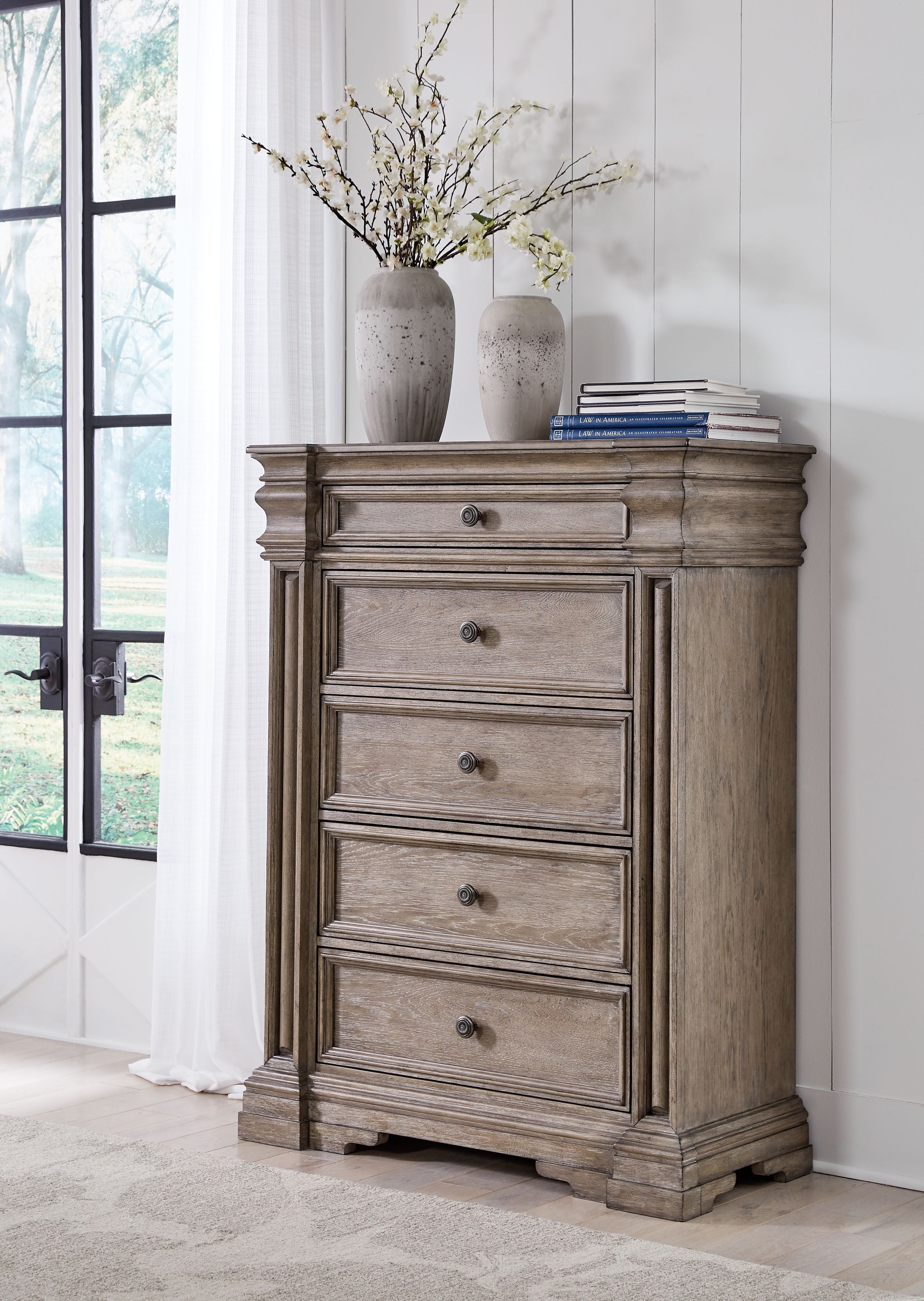 Five-drawer chest, light grayish-brown finish with metal knobs and bun feet