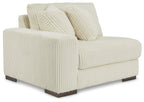 Ivory corner chair with upholstered arms and three back pillows