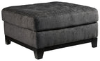 Reidshire oversized accent ottoman with square padded top and dark gray fabric, black feet