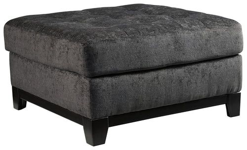 Reidshire oversized accent ottoman with square padded top and dark gray fabric, black feet