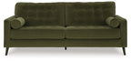 Olive green velvet sofa with tufted back and rolled arms, exposed dark legs.