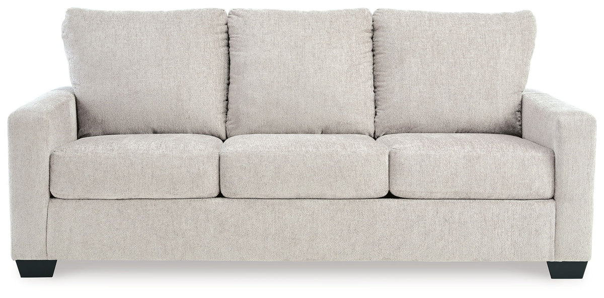 Light beige sofa sleeper with three back cushions and wide, squared arms