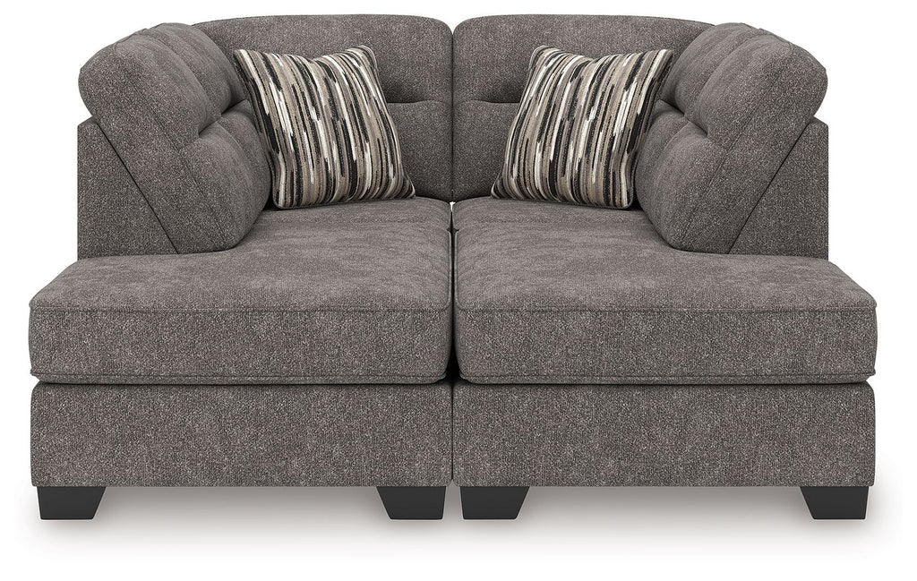 Dark gray sectional sofa with two chaise ottoman sections and two striped accent pillows