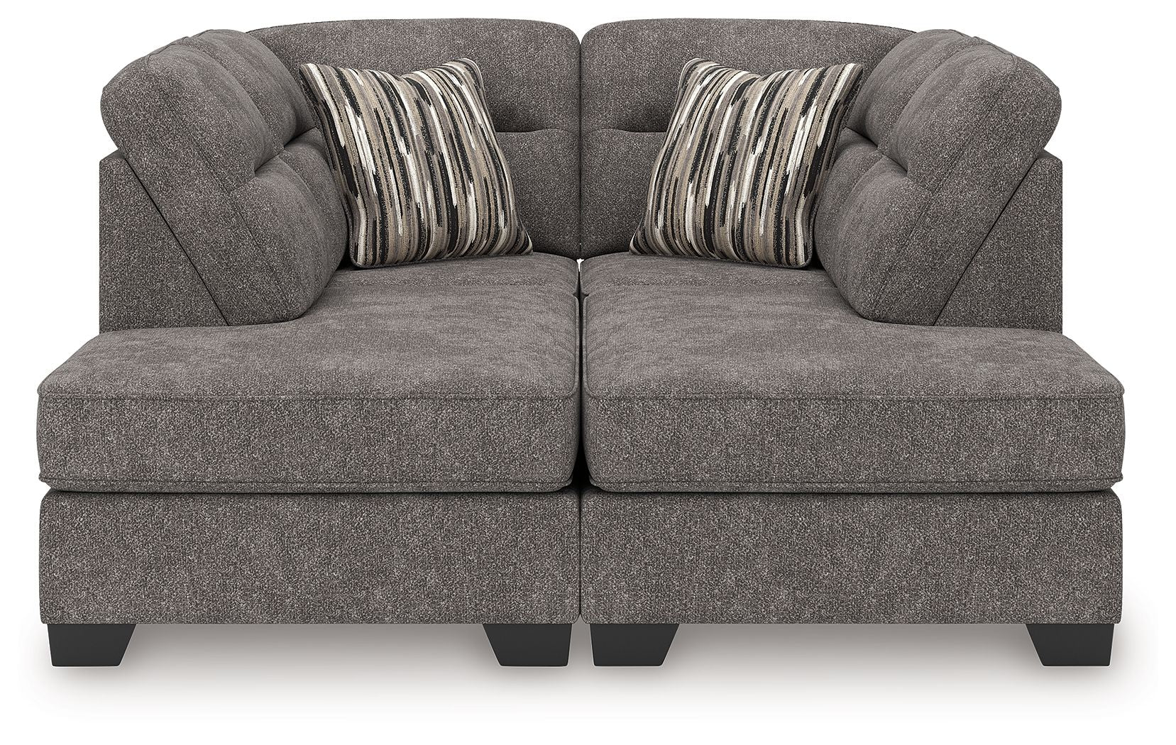 Dark gray sectional sofa with two chaise ottoman sections and two striped accent pillows