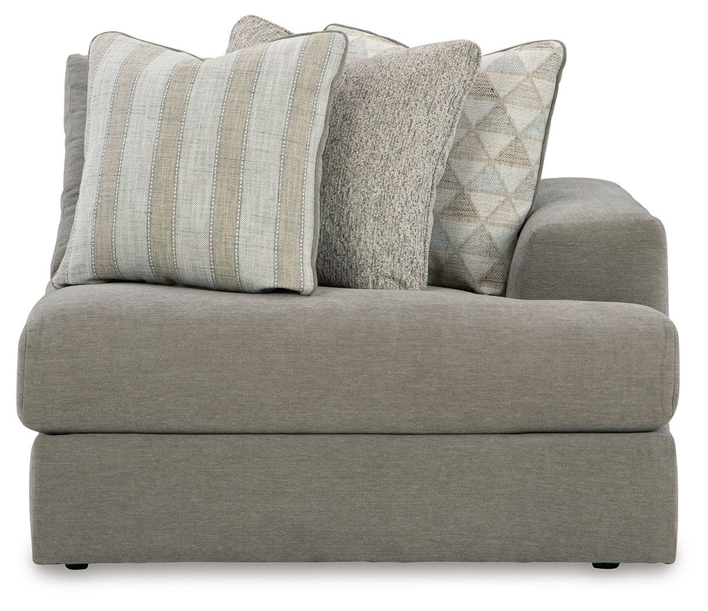 Ash gray corner chair with thick seat, armrests, and four decorative pillows