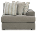 Ash gray corner chair with thick seat, armrests, and four decorative pillows