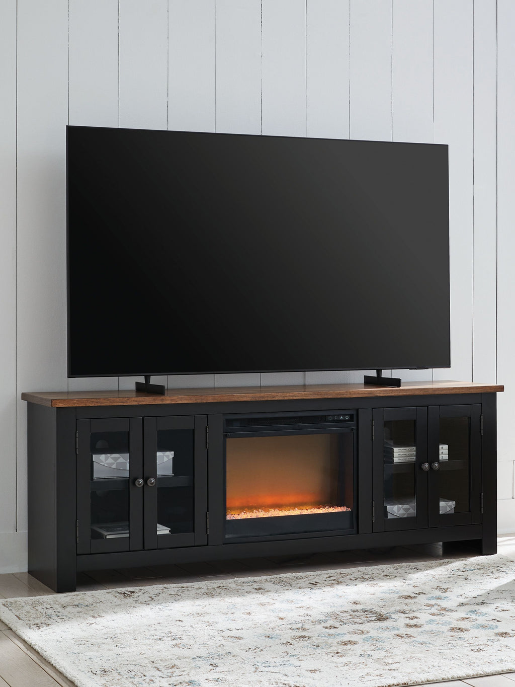 Black TV stand with electric fireplace, faux brick insert, four-door storage