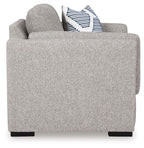 Gray upholstered chair with striped accent pillows