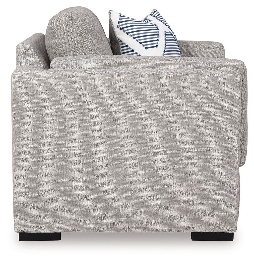 Gray upholstered chair with striped accent pillows