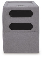 Gray upholstered console with two black oval openings and recessed top tray