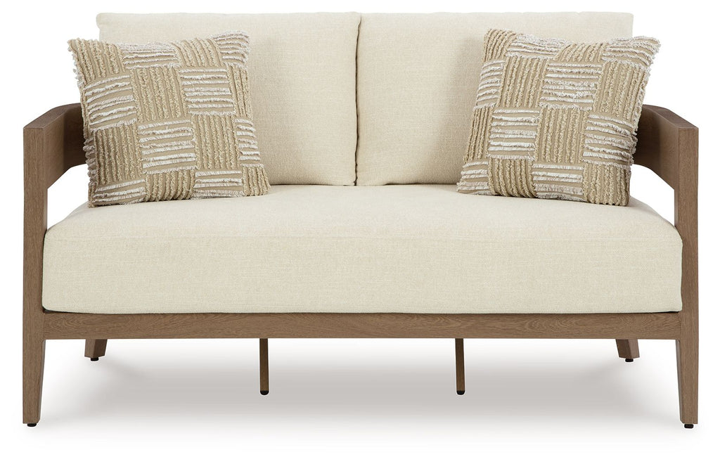 Loveseat with cushion, dark brown base and light beige backrest with two patterned pillows