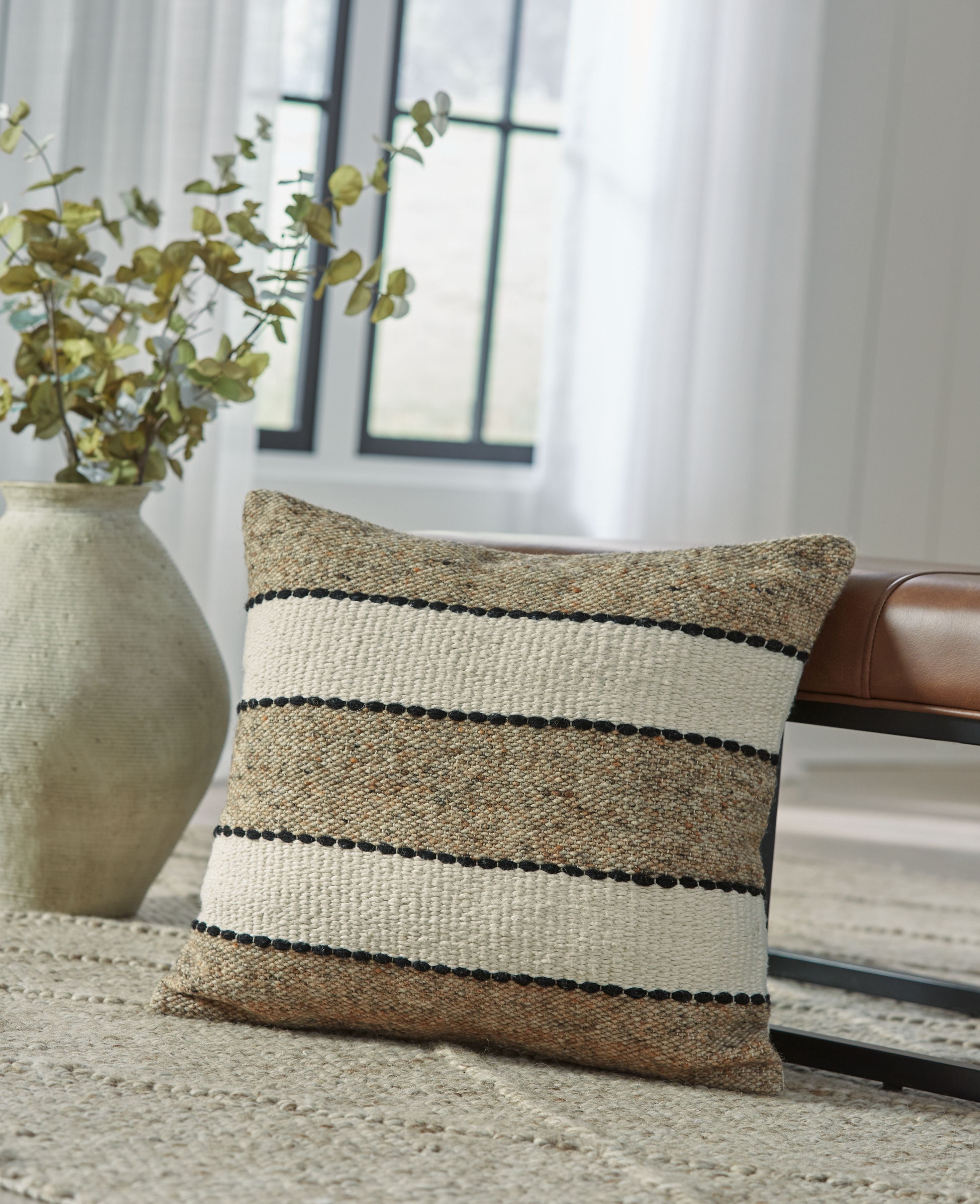 Rueford pillow with light brown weave and black beaded horizontal stripe bands