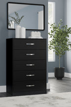 Black five-drawer chest with silver bar pulls and mirror panel on top.