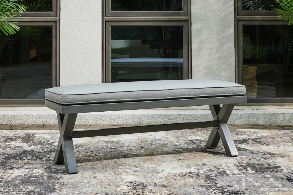 Gray outdoor bench with cushion and angled dark gray supports