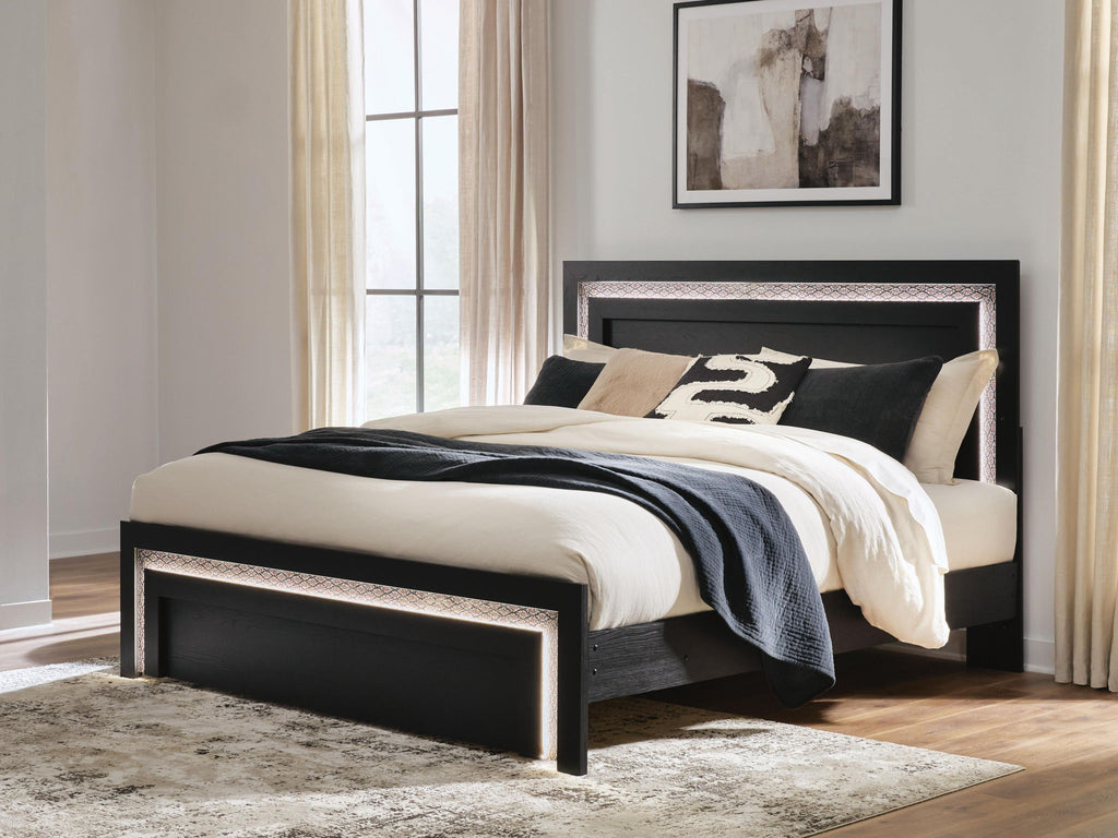 Black panel bed with tall headboard and low footboard, decorative edge trim, bedding