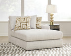 Light beige corner chaise with two patterned cushions and a wide rounded arm