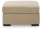 Light brown upholstered oversized accent ottoman front view with black feet
