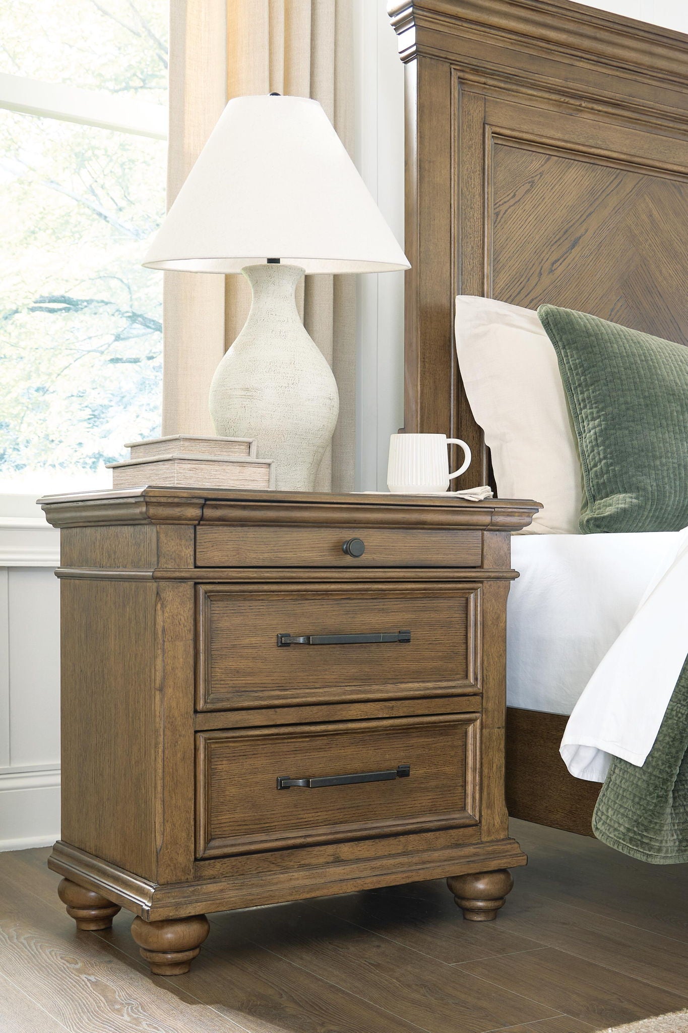 Medium brown nightstand with two drawers and metal bar pulls, turned legs