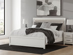 White upholstered panel bed with padded headboard and slatted posts, matching footboard