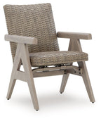 Rocking arm chair with woven beige upholstery, light wood arms and angled legs