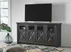 Black TV stand with gray tabletop and four X-pattern door panels; TV on top