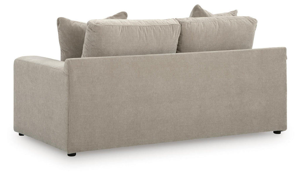 Light gray loveseat with two seat cushions and four back pillows, wide arms
