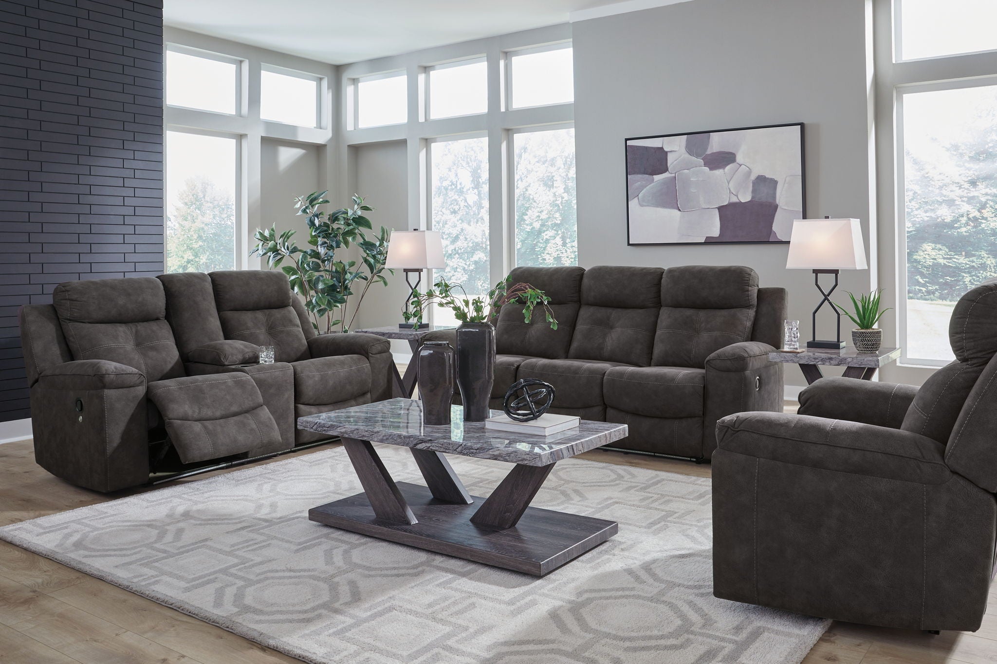 Dark gray reclining sofa and loveseat set with padded recline backs