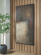 Abstract rectangular wall art with dark gray, rust, and cream texture, hanging on wall