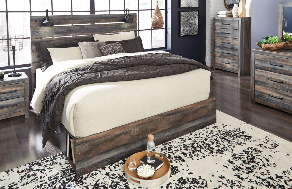 Panel bed with dark wood frame and panel headboard; beige and gray bedding with throw blankets