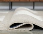 Light brown rug with rolled edge showing plush pile
