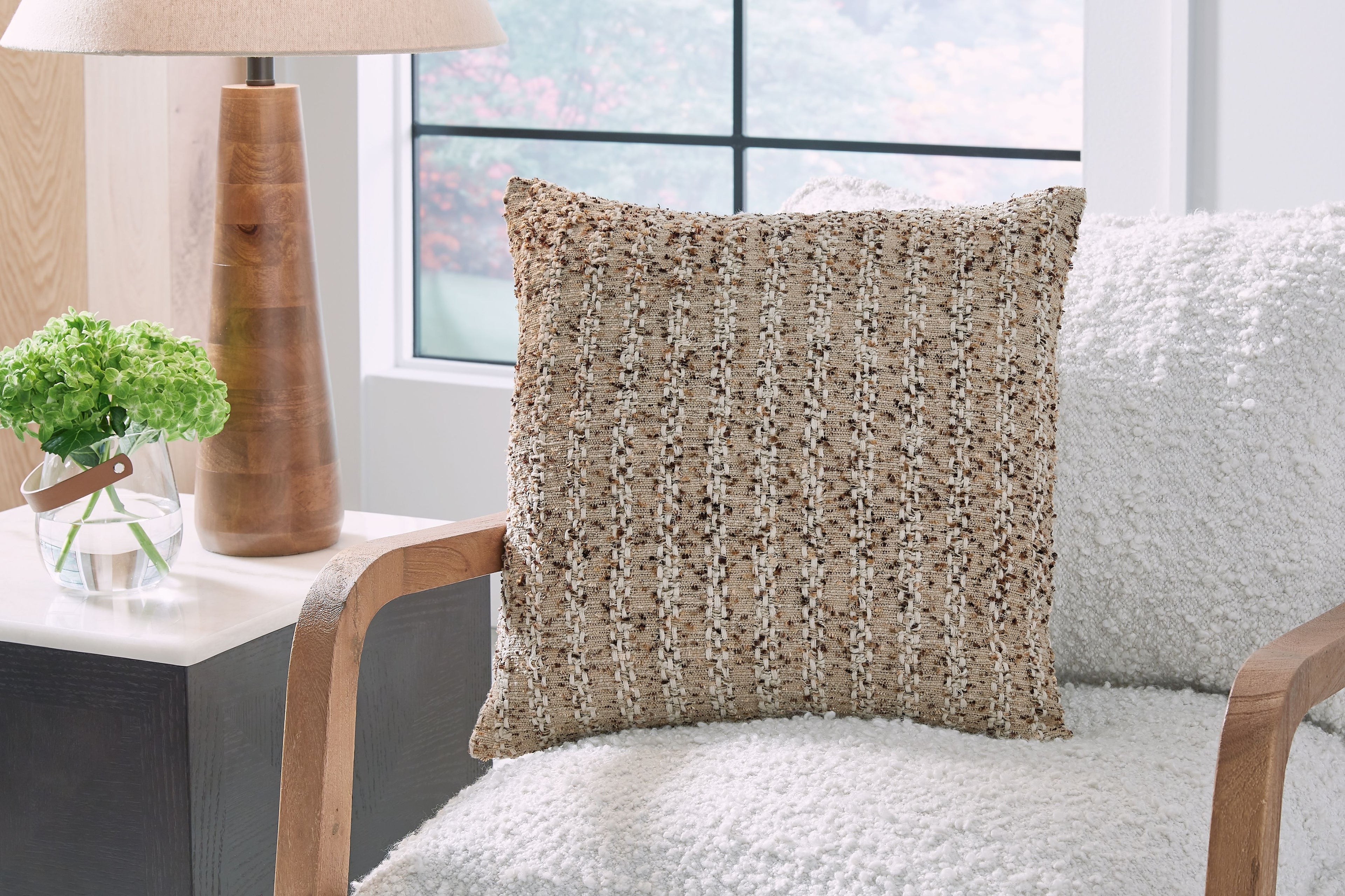 Vorlane textured pillow on upholstered chair, light brown square