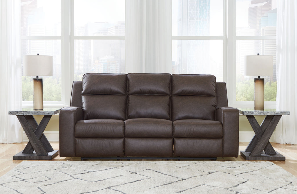 Reclining sofa with cushioned back and arms, dark brown upholstery, three seats