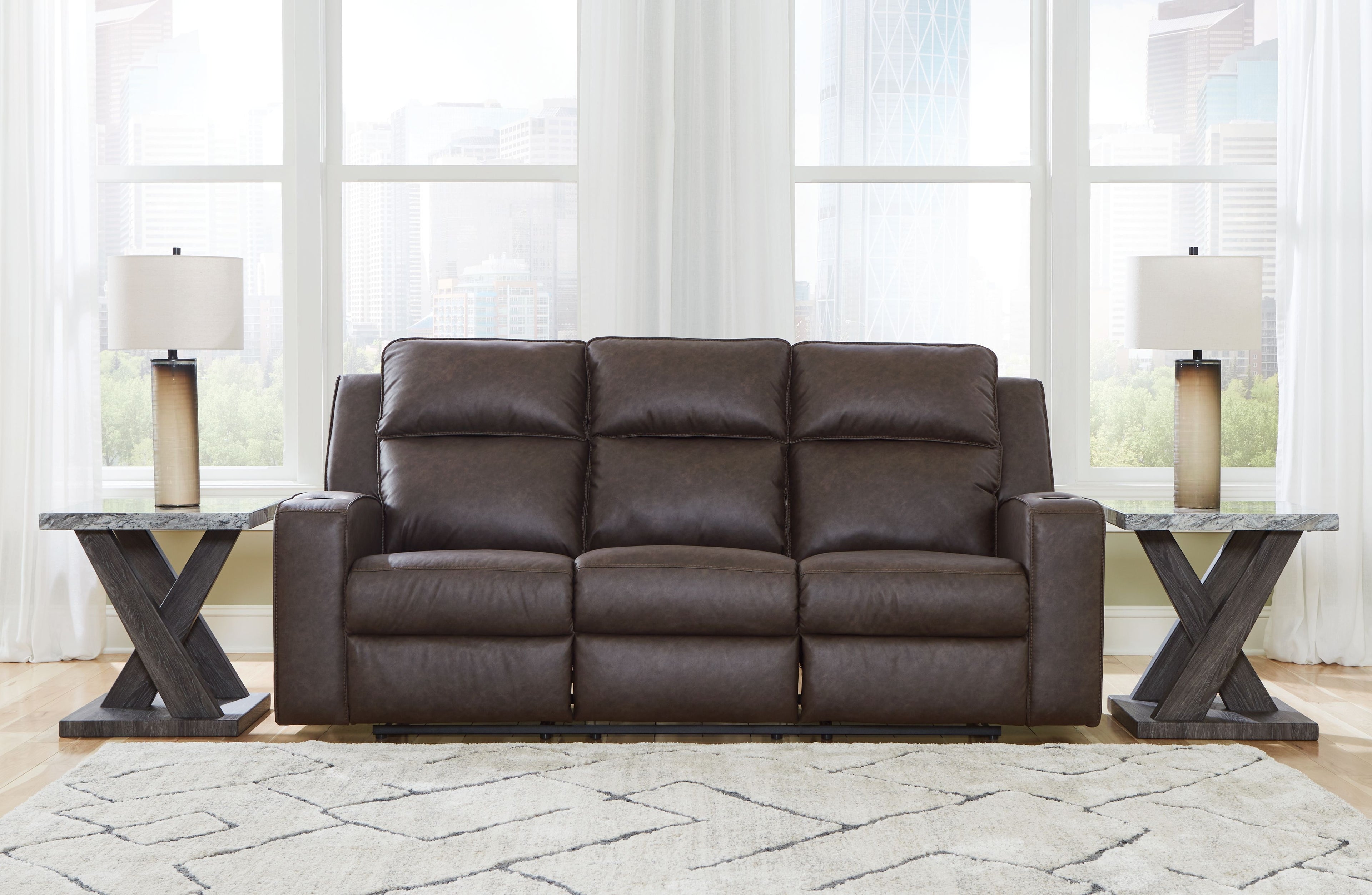 Reclining sofa with cushioned back and arms, dark brown upholstery, three seats