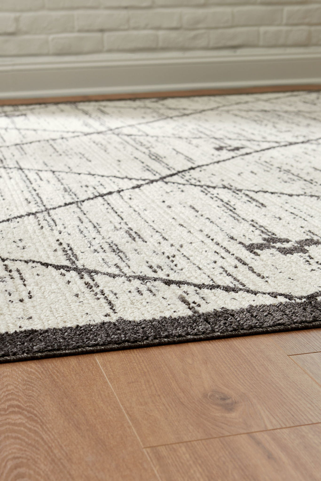 Cream and black distressed rug texture with diagonal grid lines