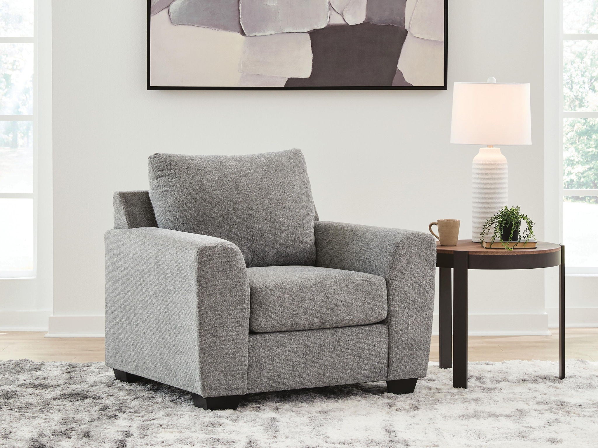 Gray upholstered lounge chair with tall back and thick seat cushion
