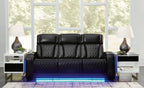 Black power reclining sofa with quilted upholstery and wide armrest panels